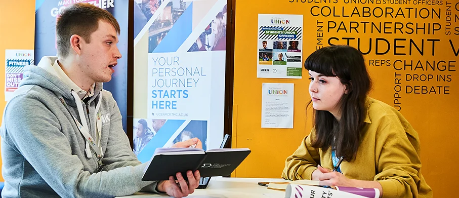 Two student reps talking to each other