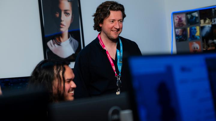 Photograph of a UCEN Manchester Lecturer and student in a classroom setting.