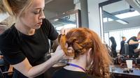 A clients hair being worked on by a hairdresser