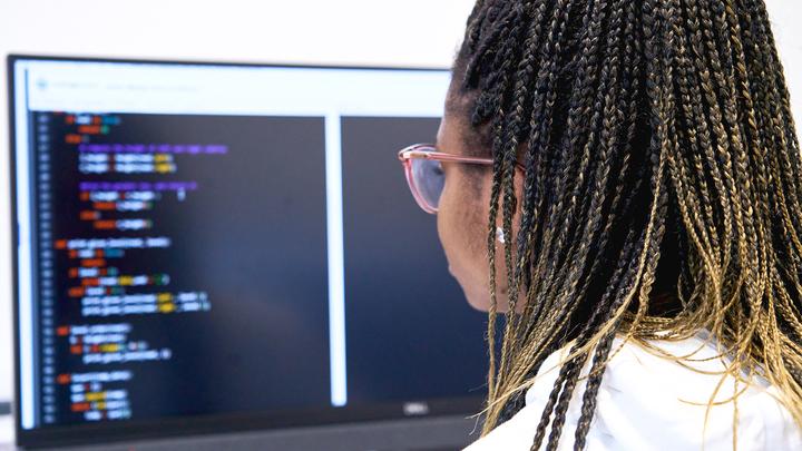 Over the shoulder view of someone using a computer