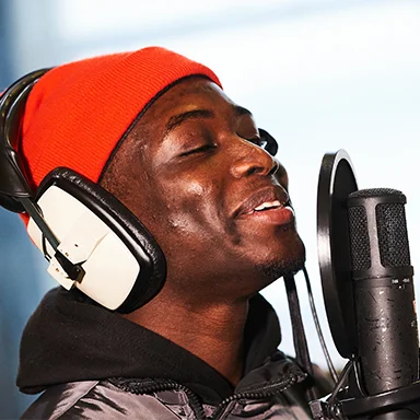 Close-up of an artist singing into a microphone