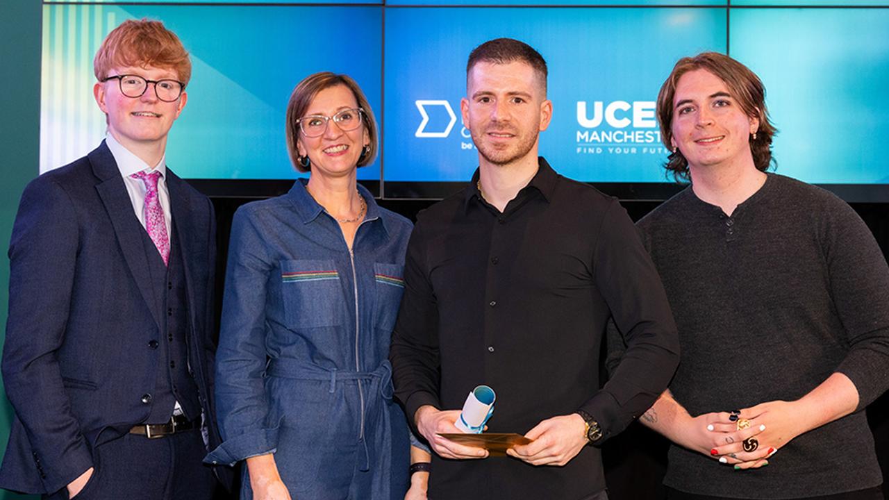 Photograph of Aitor Martinez Gonzalez on stage collecting the UCEN Manchester Student of the Year award.