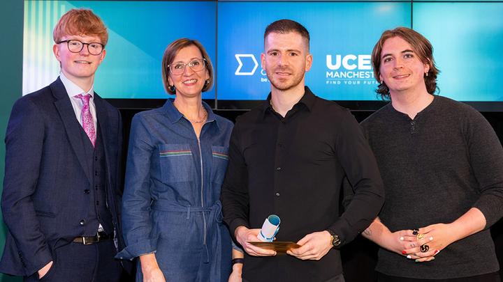Photograph of Aitor Martinez Gonzalez on stage collecting the UCEN Manchester Student of the Year award.