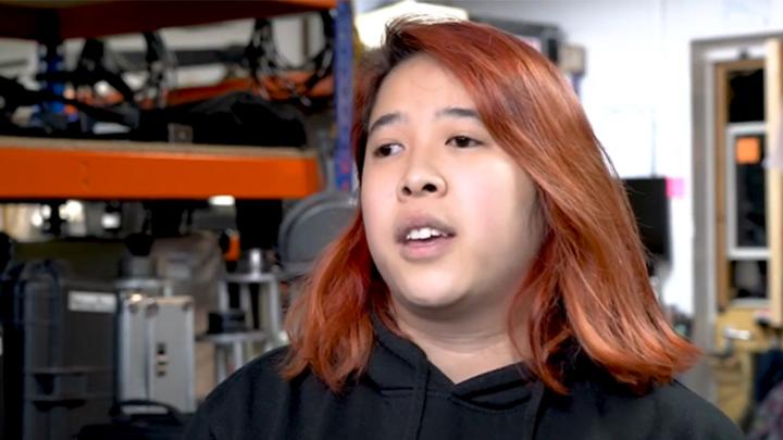 Sammy is looking beyond the camera as this is a screenshot from her video interview.