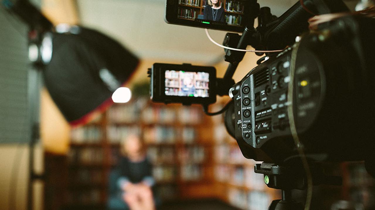 Close-up of a camera filming a set