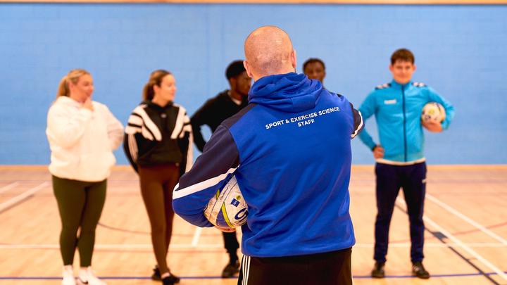 UCEN Students being directed in the Sports Hall by a UCEN Sport Tutor