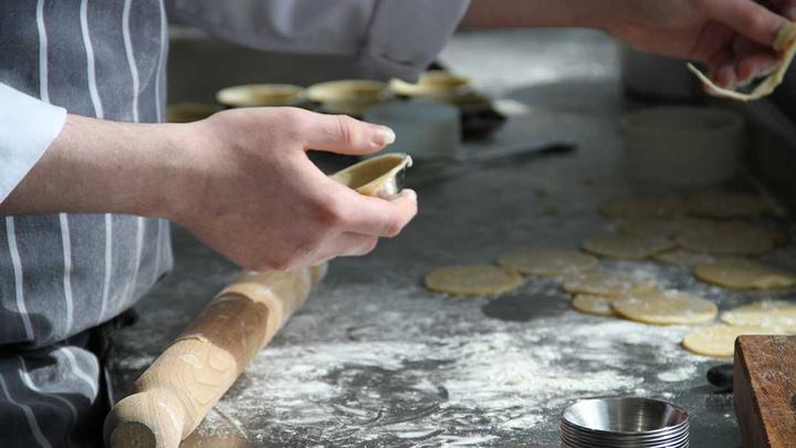 Dough being rolled out on a counter