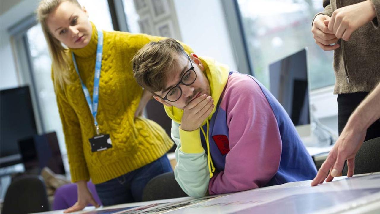 UCEN Manchester student with tutors in class.