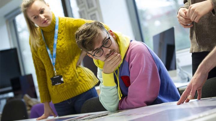 UCEN Manchester student with tutors in class.