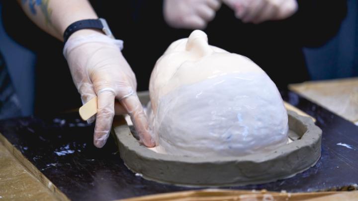 Close up of hands moulding clay