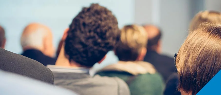 A group of people sitting and seen from the back
