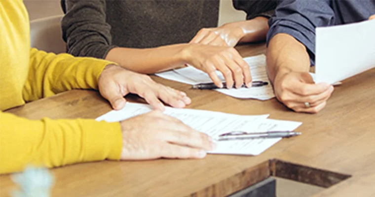 Close-up of two people working at a desk